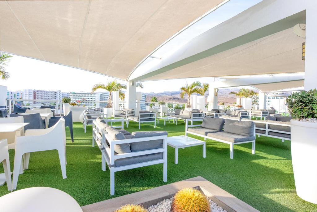 a patio with tables and chairs on a roof at Labranda Marieta & Spa - Adults Only in Playa del Ingles