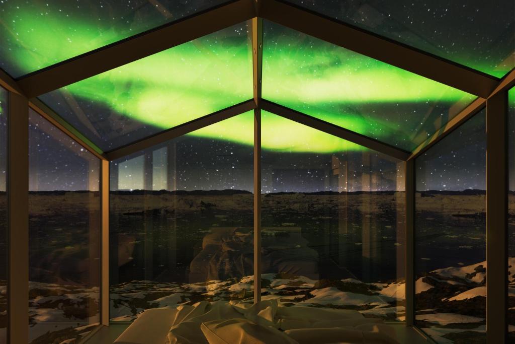 an igloo with a view of the northern lights at Hotel Arctic in Ilulissat