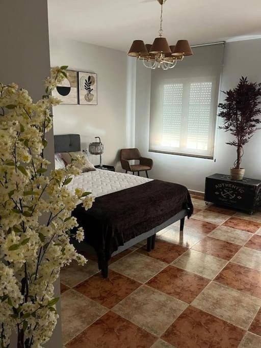 Un dormitorio con una cama y flores. en Apartamento 7 adultos, en Rueda