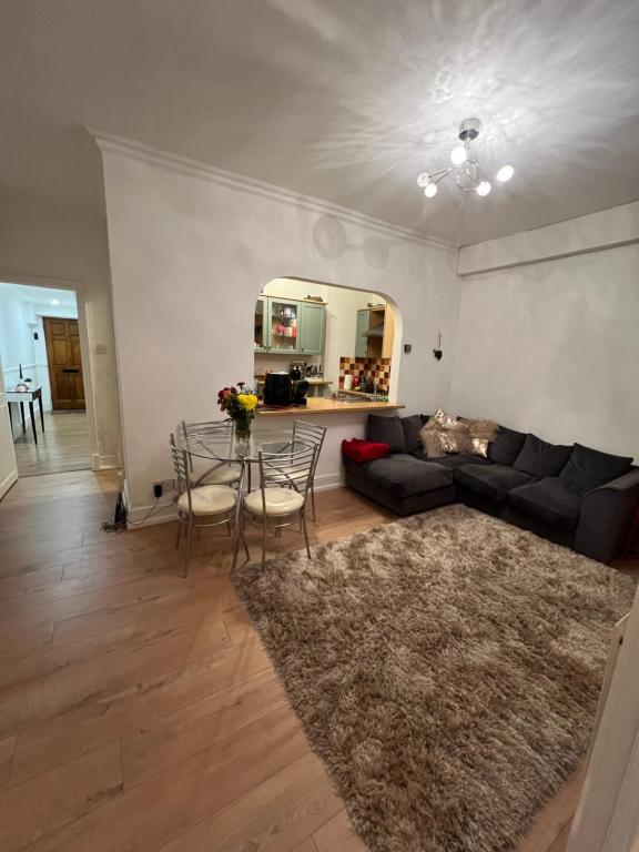 a living room with a couch and a table at Double bedroom in chelsea in London
