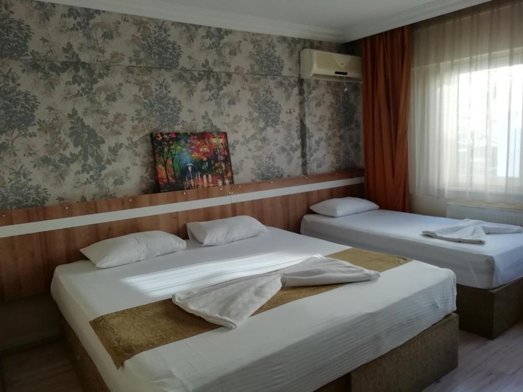 Postel nebo postele na pokoji v ubytování Grand Ece Hotel