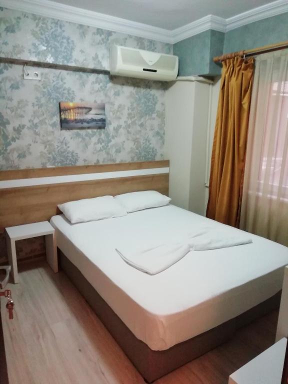 Postel nebo postele na pokoji v ubytování Grand Ece Hotel