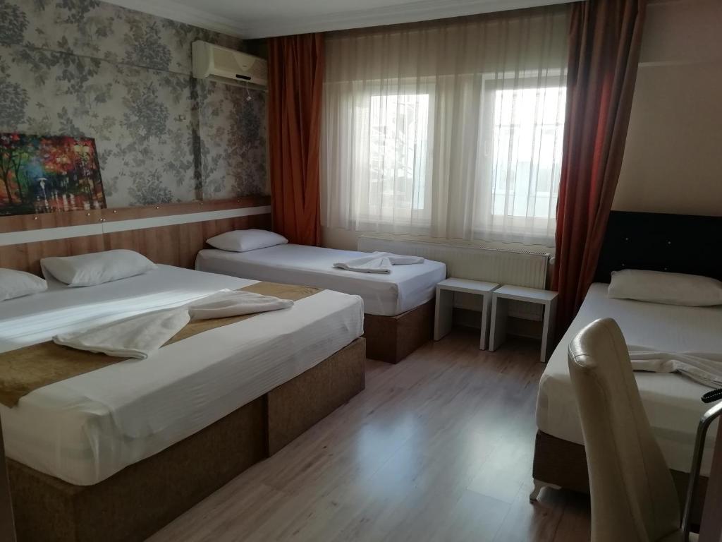 Postel nebo postele na pokoji v ubytování Grand Ece Hotel
