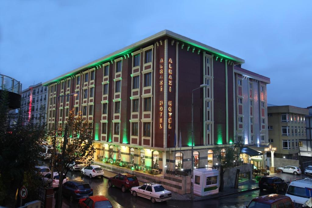 イスタンブールにあるAlrazi Hotel Floryaの駐車場車を停めた大きな建物