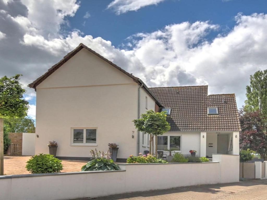 a white house with a brown roof at Holiday apartment Schliekieker in Kopperby