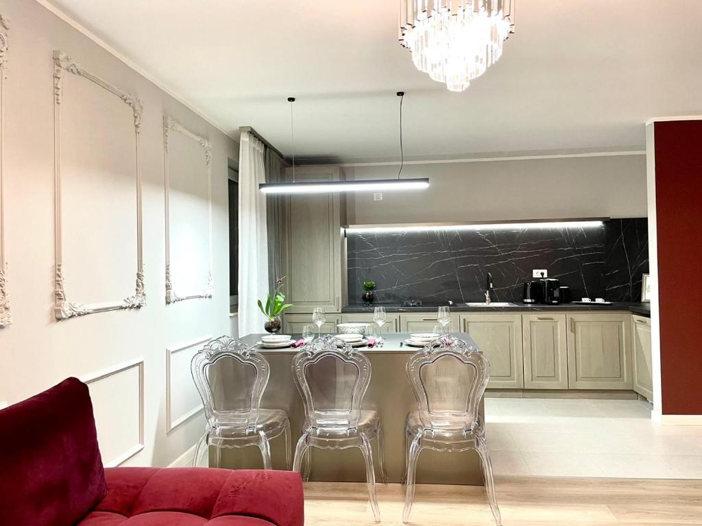 a kitchen with a table and chairs and a counter at STUDIO 92- URBAN PLAZA in Braşov