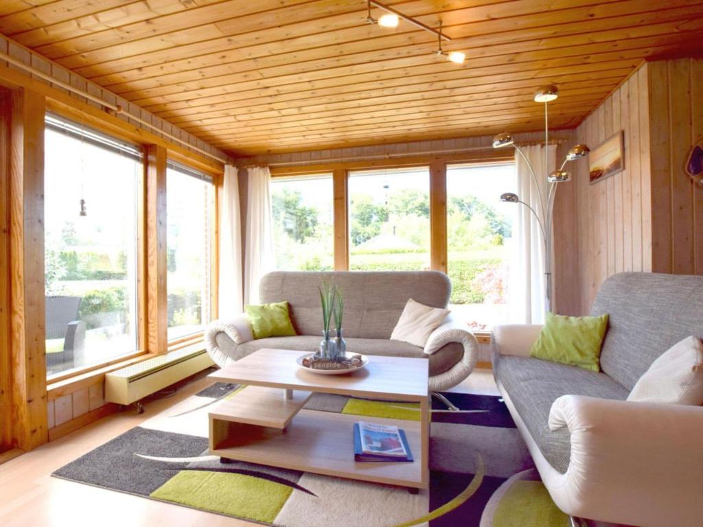 a living room with a couch and a table at Holiday home coastal dream in Schönhagen