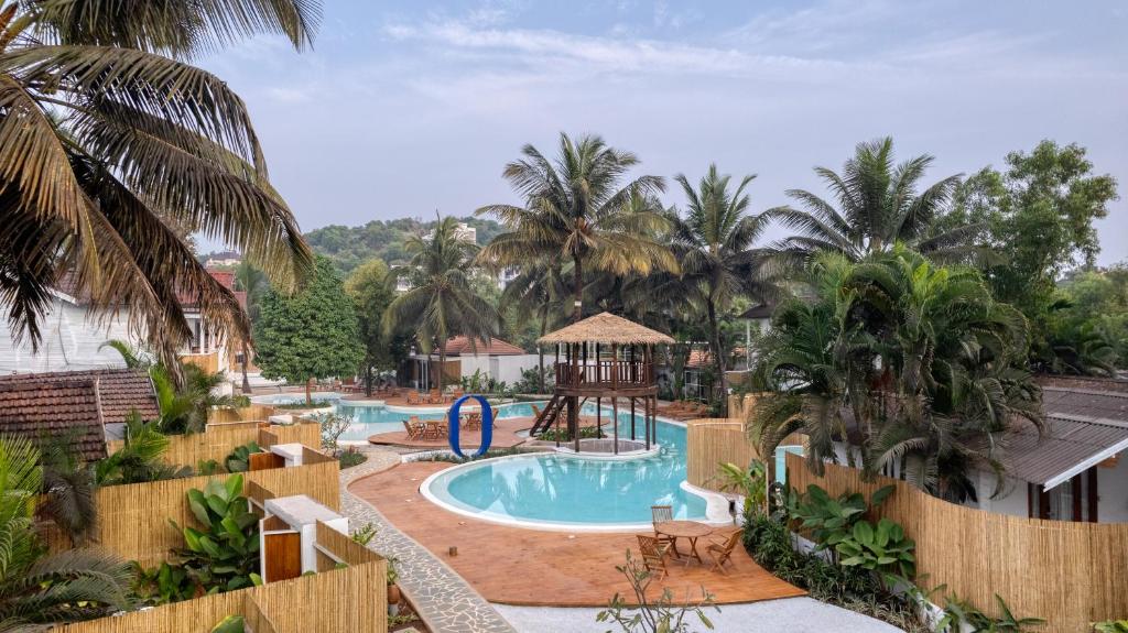 a resort pool with a gazebo and a playground at Azora by Ayatana, Goa in Morjim