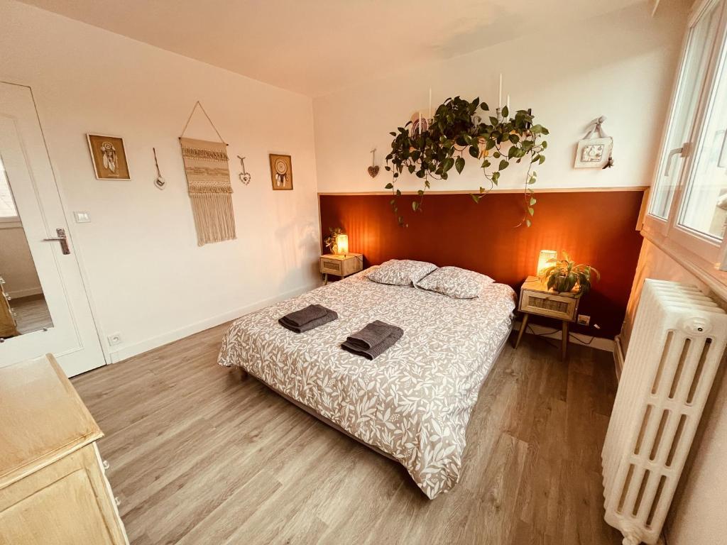 a bedroom with a large bed in a room at Le Scarron - centre ville - garage privé - 4pers in Le Mans
