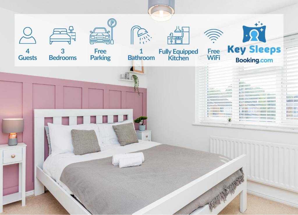 a bedroom with a white bed with a pink wall at Cosy Contractor House & Garden & Free Parking in Swindon