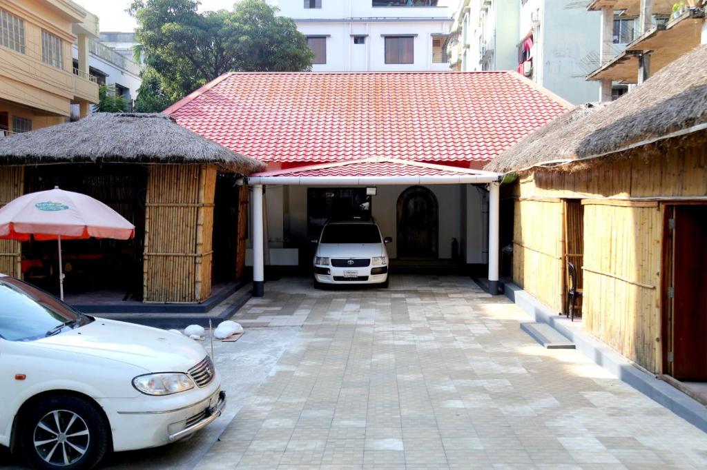 a white car is parked in a garage at Nirapod Holiday Home in Sylhet