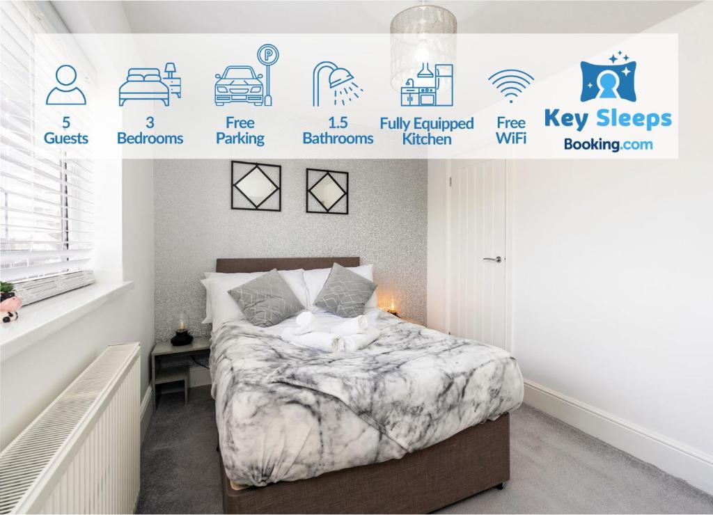 a bedroom with a bed and a poster of key sights at Modern Contractor House & Free Parking & Garden in Hull