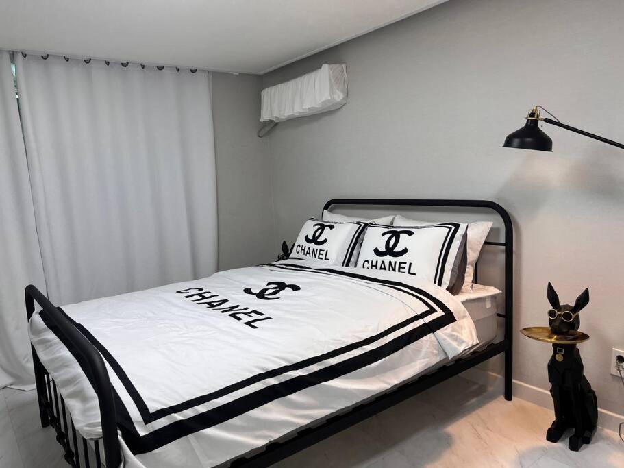 um quarto com uma cama com almofadas pretas e brancas em Pet Friendly 305 em Suncheon