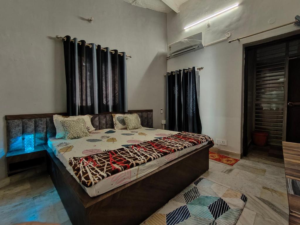a bedroom with a large bed in a room at Naari home stay in Mathura