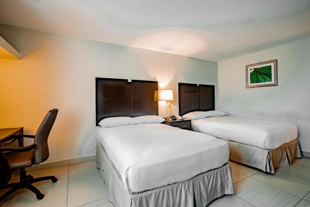 Uma cama ou camas num quarto em Studio Coliving Hotel