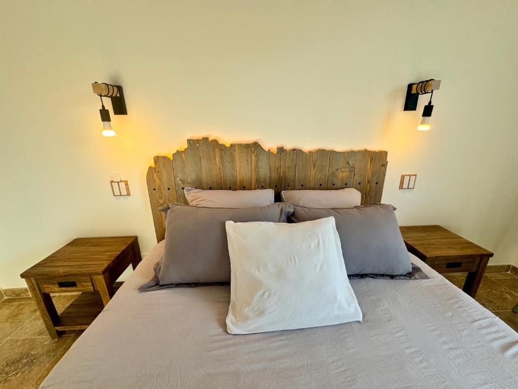 a bedroom with a large bed with a wooden headboard at Mas CamPau in Fontvieille
