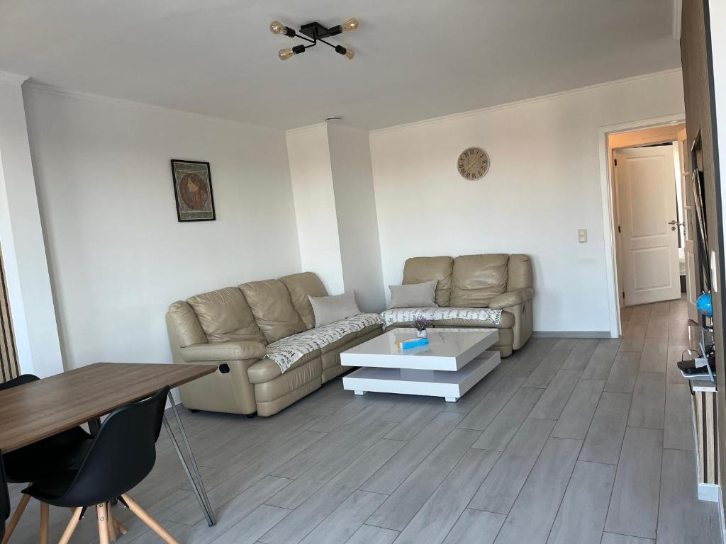 a living room with a couch and a table at Apartment Brussels Airport and NATO OTAN headquarters in Machelen