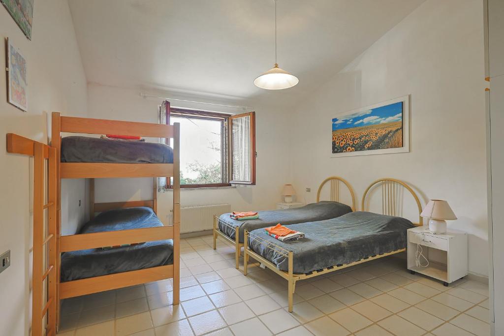 1 dormitorio con 2 literas y ventana en Agriturismo Campo al Crognolo, en Sassofortino