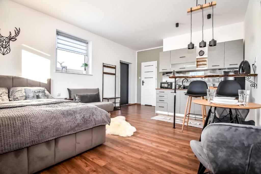 una camera con letto, tavolo e sedie di Apartament Magiczny Widok z widokiem na góry a Poronin