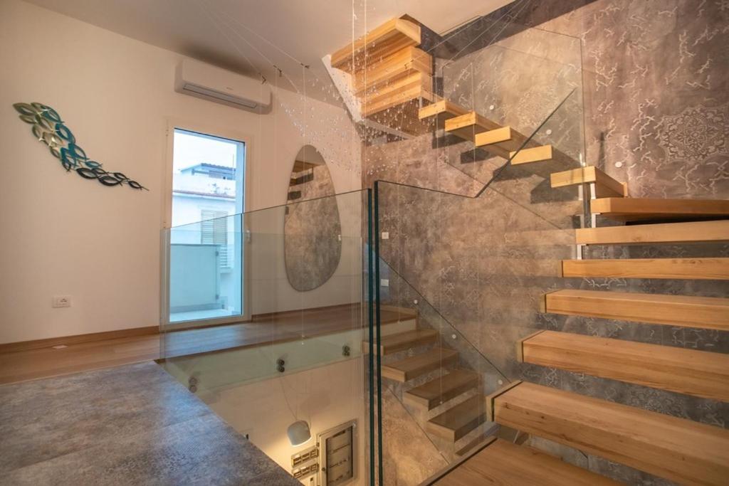 a glass staircase in a house with a window at Guest House Azzurra in Lampedusa