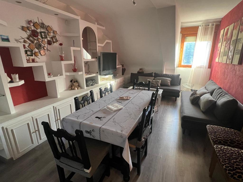 a living room with a table and a couch at La Perla del Pirineo in Jaca