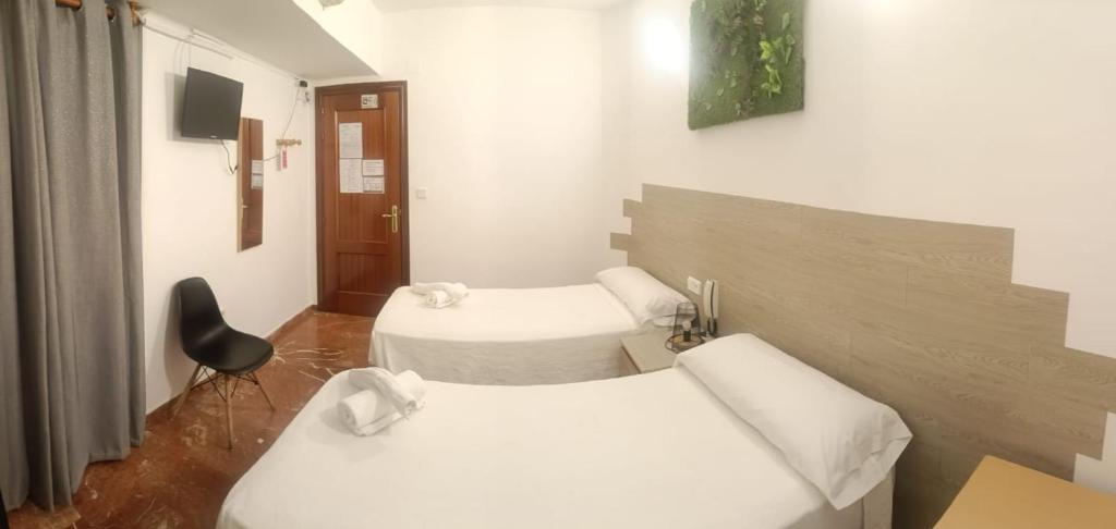 A bed or beds in a room at Hostal Nevot