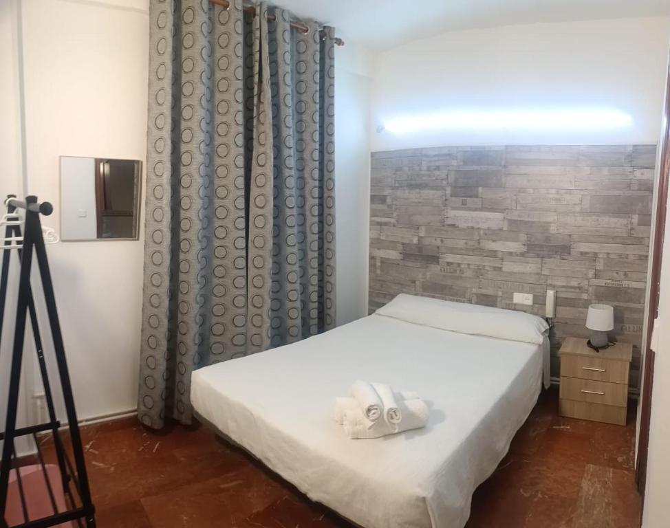 A bed or beds in a room at Hostal Nevot