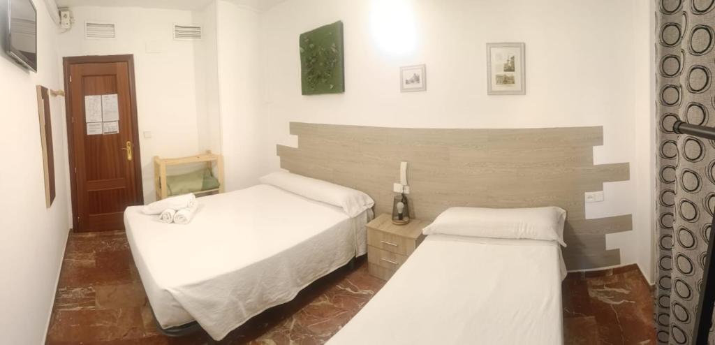 A bed or beds in a room at Hostal Nevot