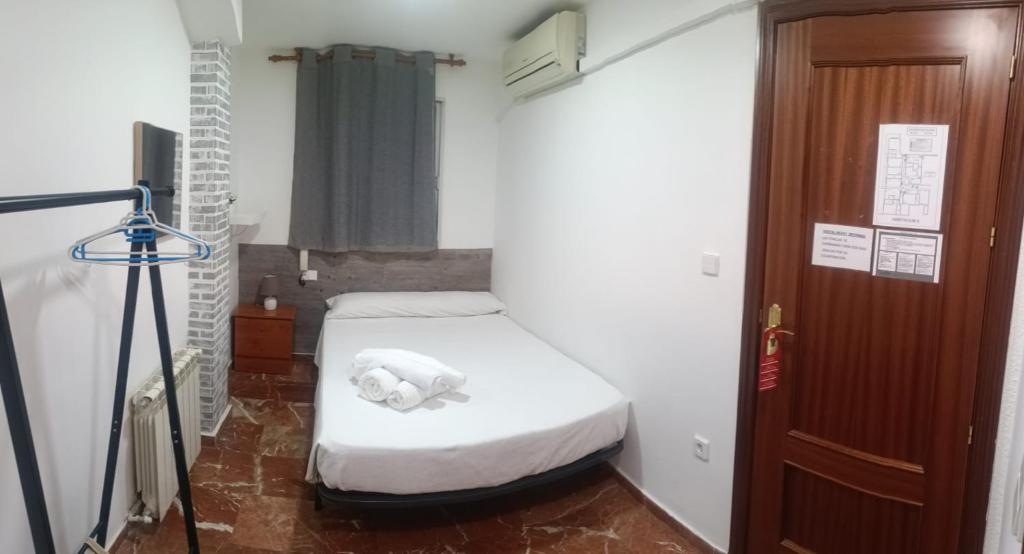 A bed or beds in a room at Hostal Nevot