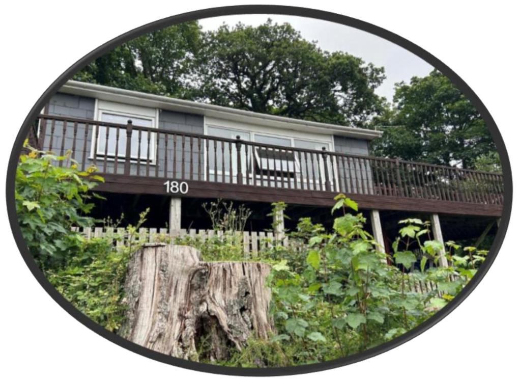 an image of a house with a deck at 180 River View Cabin in Caeathro