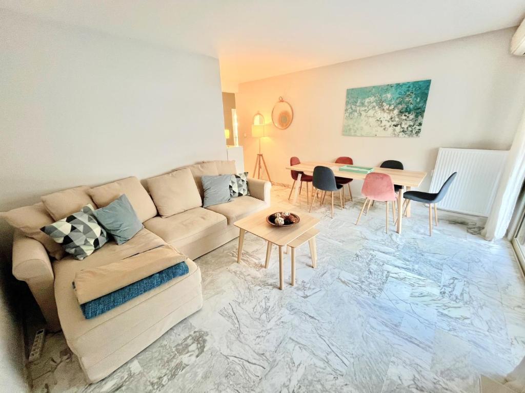 a living room with a couch and a table at Branly 2, by Welcome to Cannes in Cannes