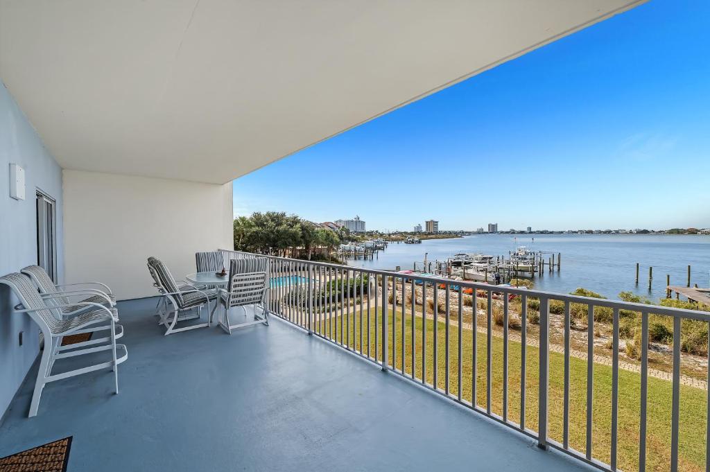 a balcony with chairs and a view of the water at South Harbour Unit 2D in Pensacola Beach