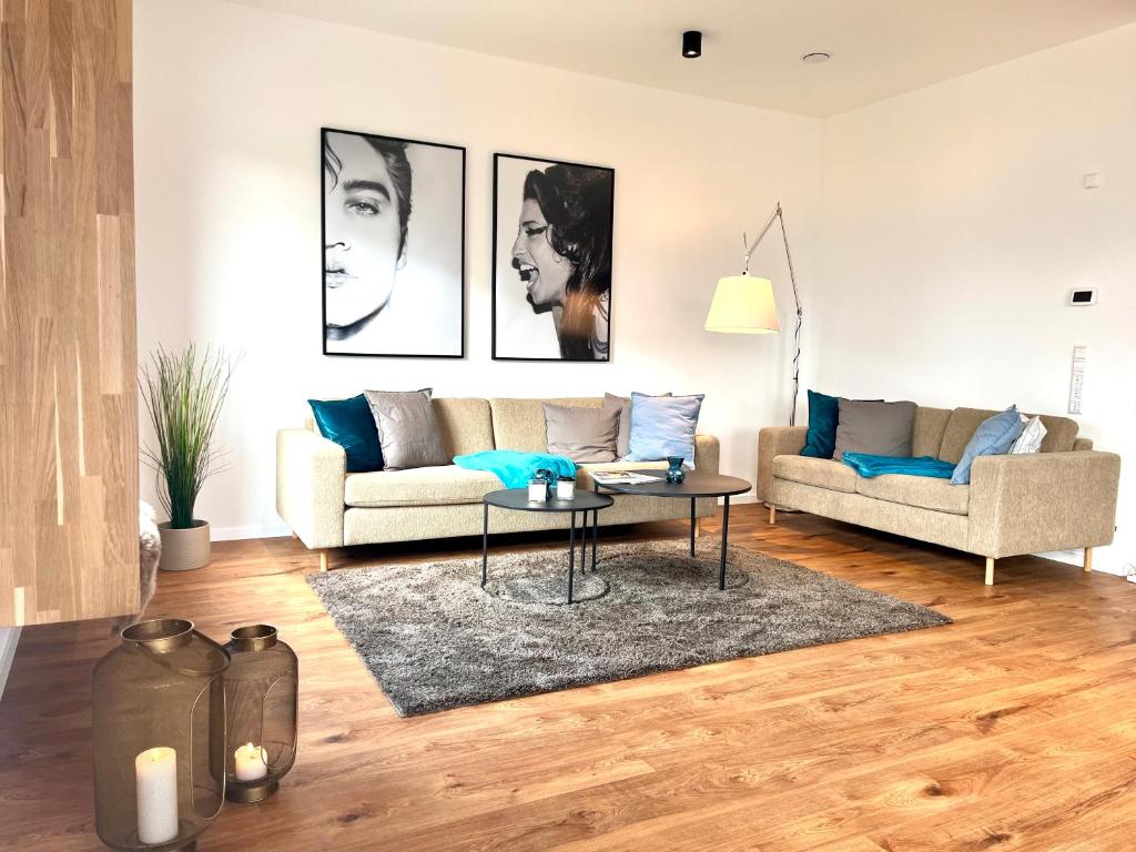 a living room with a couch and a table at Luxus-Ferienhaus mit Saunen und großem Garten in Göhren-Lebbin