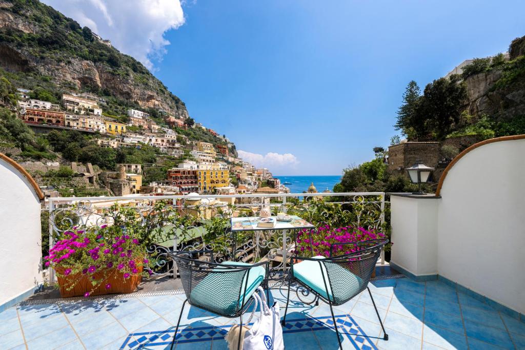 a balcony with chairs and a view of the amalfi coast at Hotel Royal Prisco in Positano