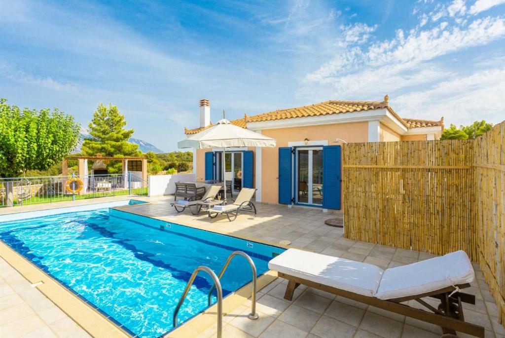 a swimming pool in front of a house at Europe Villa Io in Fokáta