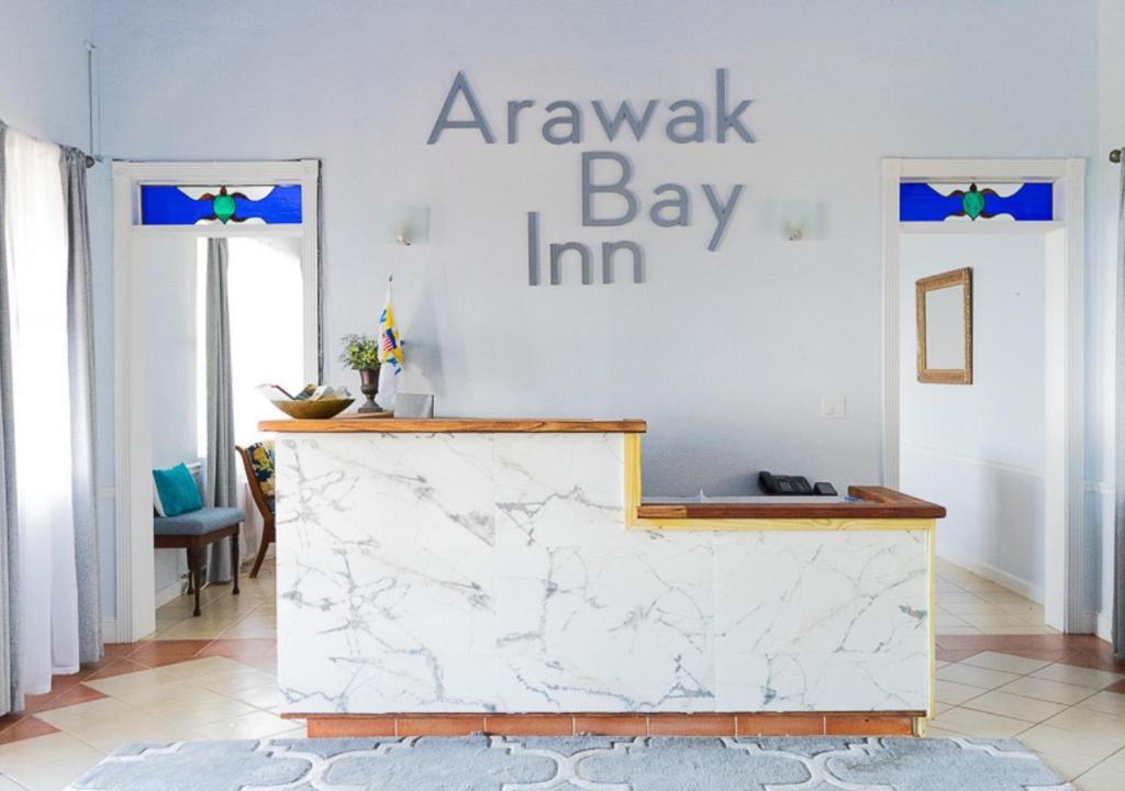 a white marble counter in a room with a sign on the wall at Arawak Bay: Inn at Salt River in Christiansted