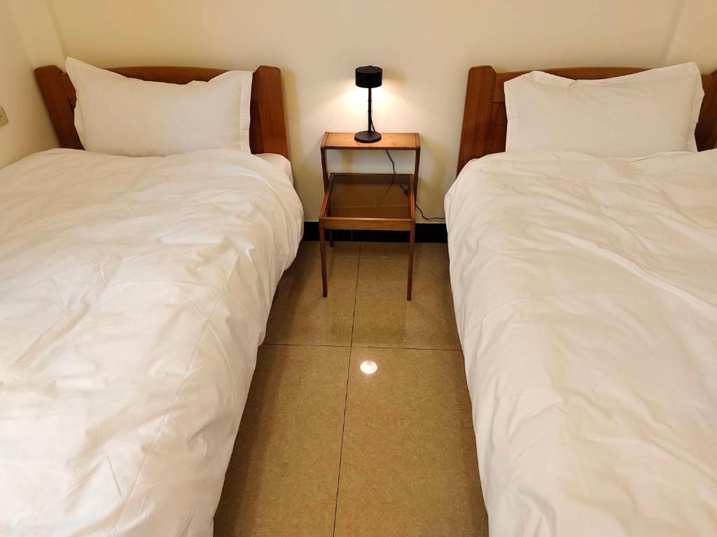 Postel nebo postele na pokoji v ubytování 小憩人輕旅
