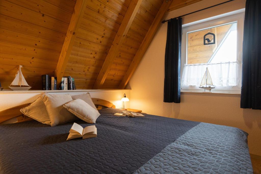 a bedroom with a large bed with a window at MP40 - Strandvogt 3 Komfort in Dorum Neufeld