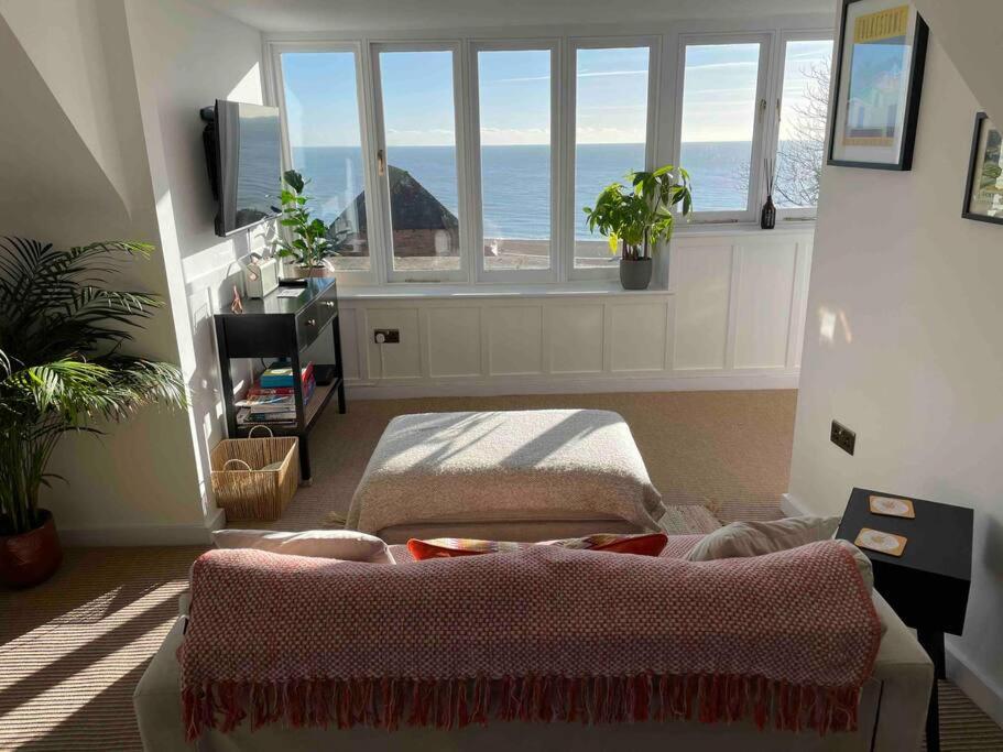 uma sala de estar com um sofá e uma janela em The Turret- the best view in Folkestone em Folkestone