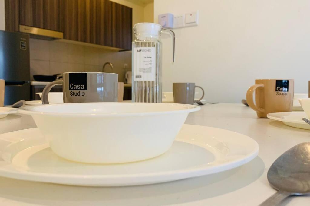 a bowl on a plate on a kitchen counter at 3 Bed Backpack Edusphere Suite in Cyberjaya