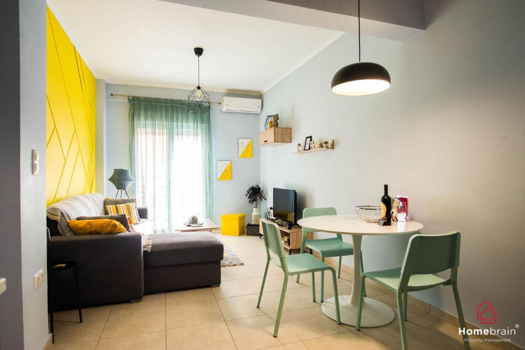 a living room with a table and a couch at Antony's City-Center Project by Homebrain in Alexandroupoli