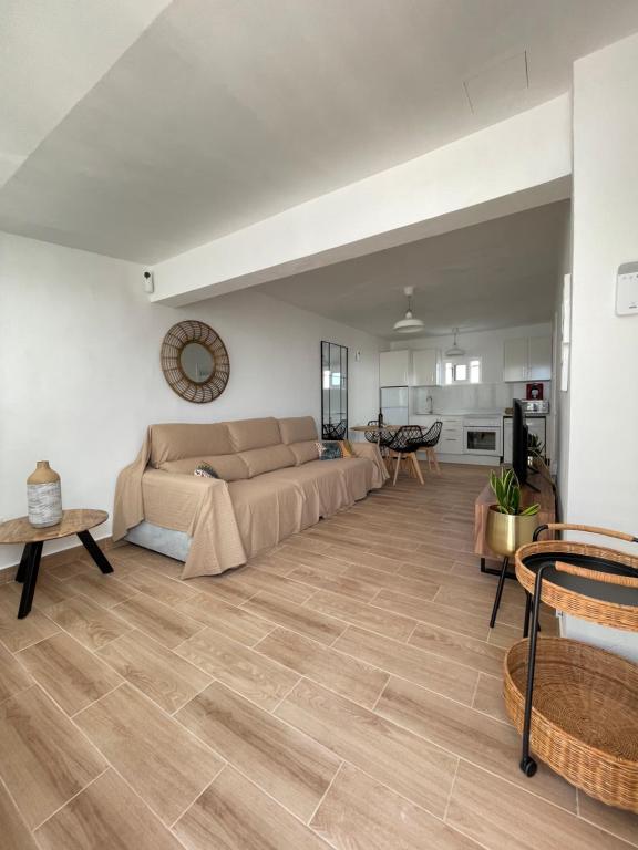 a living room with a couch and a table at Bungalow Ara in Puerto del Carmen