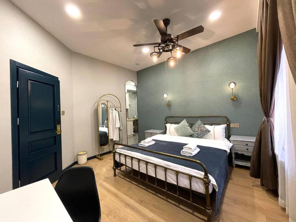 a bedroom with a bed and a ceiling fan at Apart Hotel Console in Tbilisi City