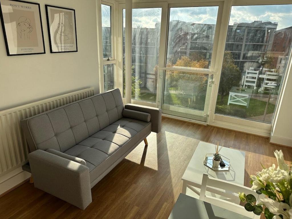 a living room with a couch and a table at Luxury 1 Bedroom Apartment - City Centre - Balcony - Near O2 Academy in Birmingham