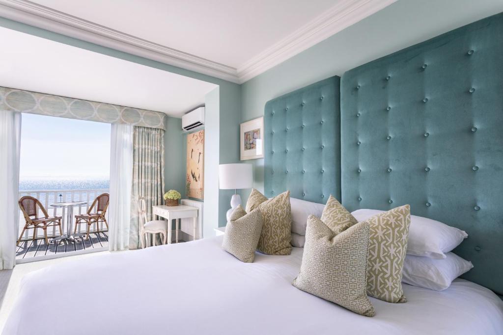 a bedroom with a large bed and a large window at Roslin Beach Hotel in Southend-on-Sea