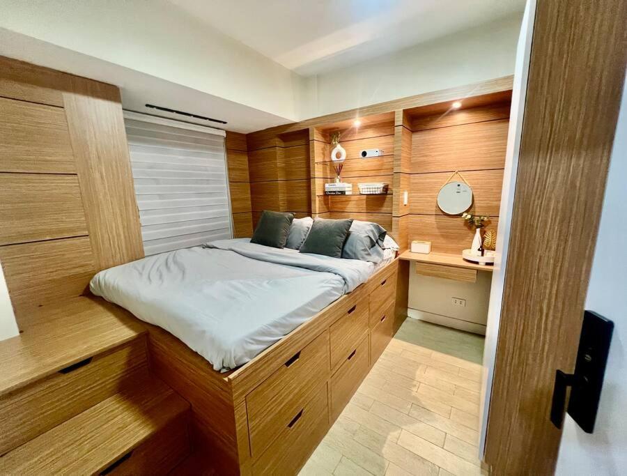 a small bedroom with a bed in a boat at NAIA T3 -10 PERCENT OFF JUNE GRADUATION PROMO- Fully Interiored 1 BR Unit in Manila