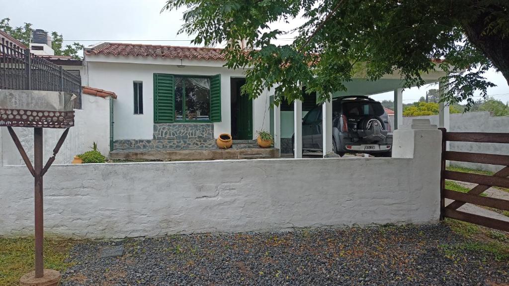a white house with a fence in front of it at Chalet MAX in Bialet Massé