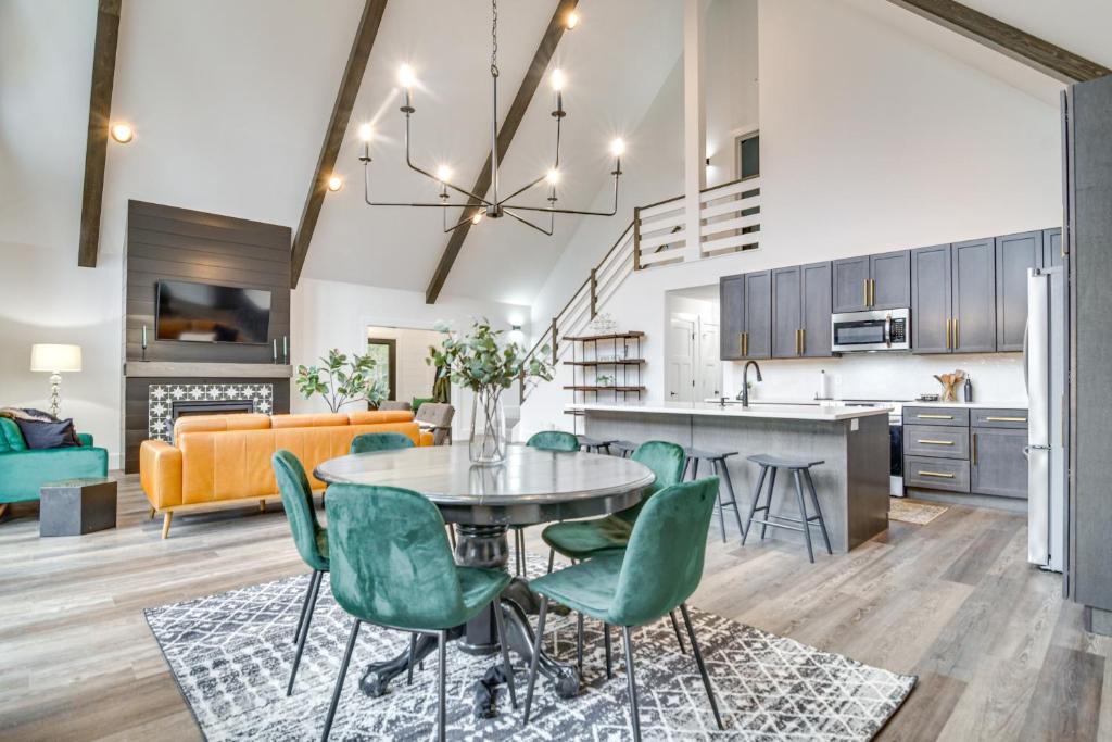 a kitchen and living room with a table and chairs at Mountain-View Bethel Cabin Game Room and Deck in Bethel