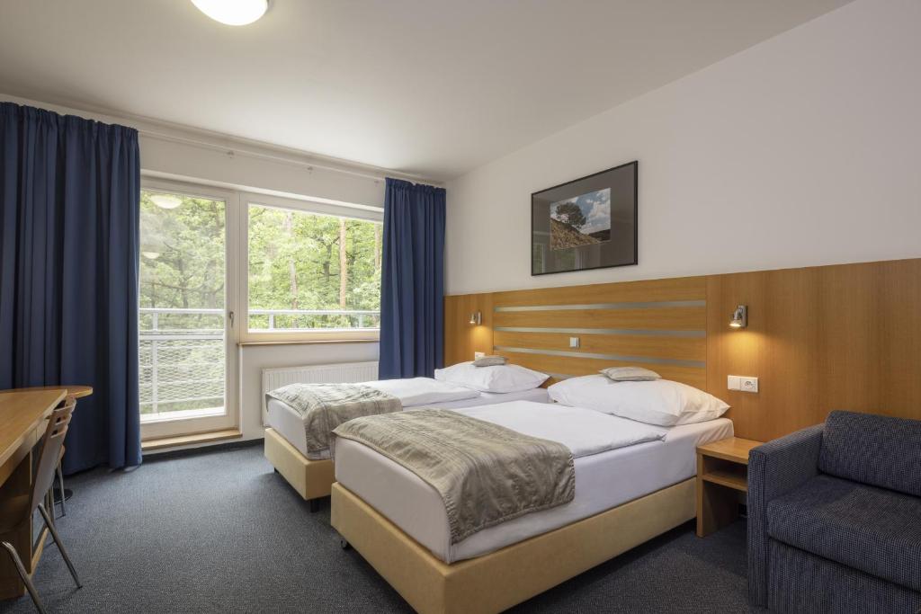 Postel nebo postele na pokoji v ubytování Hotel Port Doksy