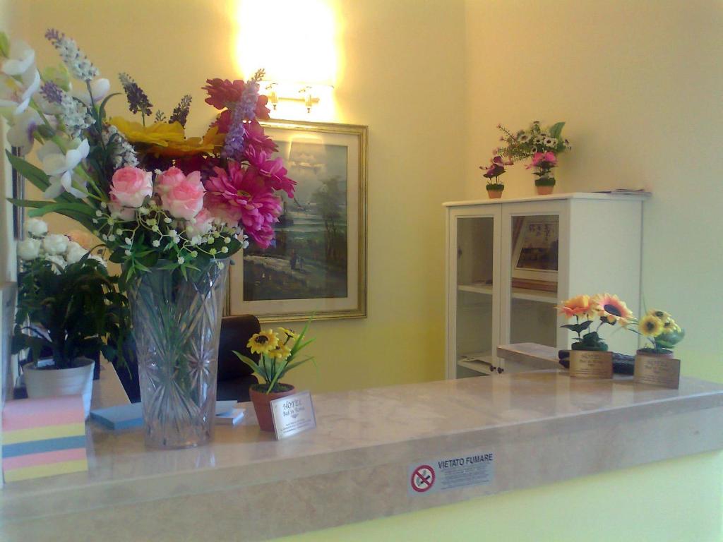 a counter with a vase of flowers on it at Bed In Roma in Rome